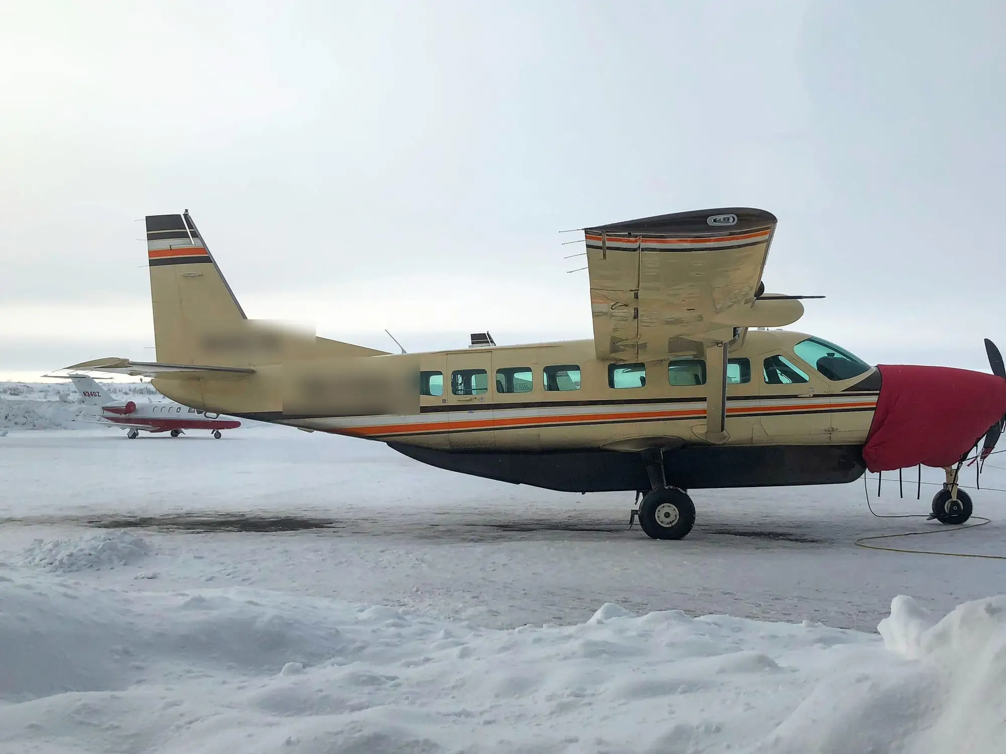 A Cessna Caravan parked on a snow-covered apron