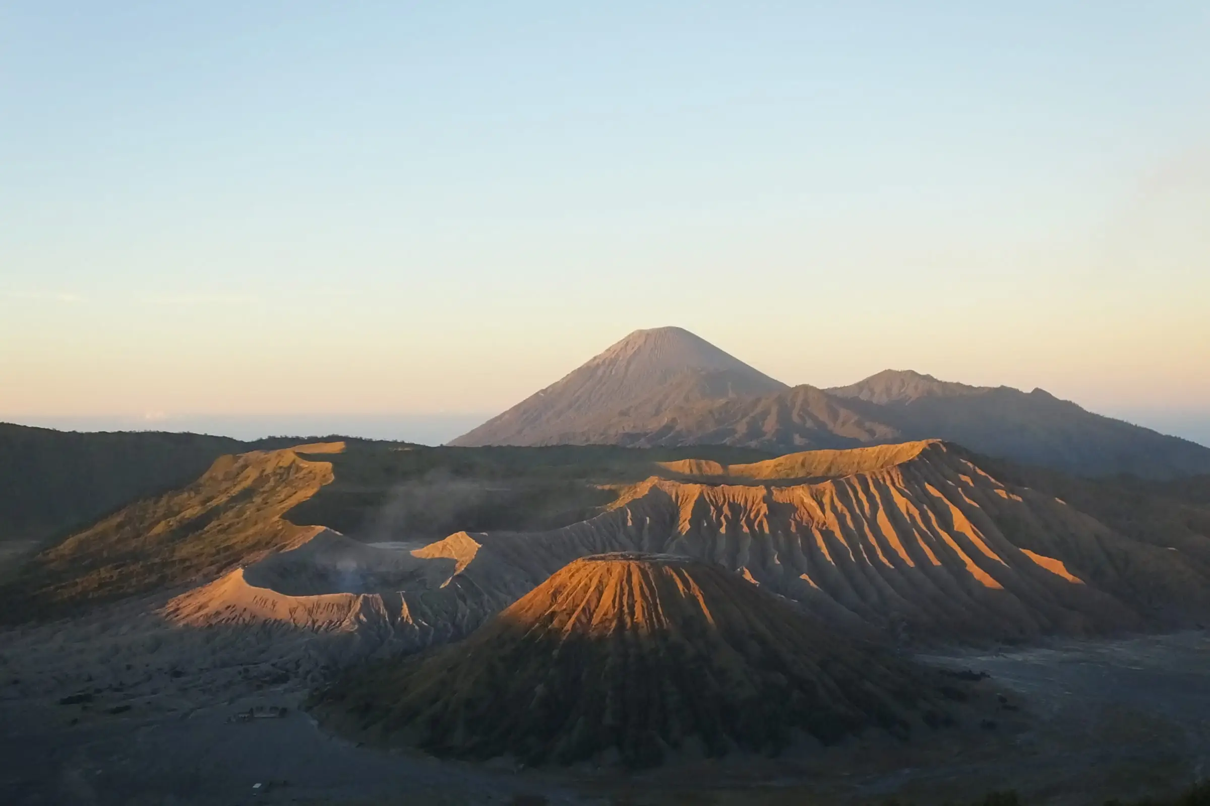 Volcanic cones rising from an ash plain at first light